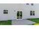 Backyard features a concrete patio and sliding glass door leading into the home at 261 Hawksmoore Ln, Lillington, NC 27546