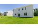 Home featuring a well-manicured lawn and sliding glass door at 261 Hawksmoore Ln, Lillington, NC 27546