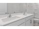 Bright bathroom featuring double sinks, a large mirror, white cabinets, and tile flooring at 261 Hawksmoore Ln, Lillington, NC 27546