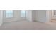 Empty bedroom with neutral carpet, white walls, baseboards and two windows with horizontal blinds at 261 Hawksmoore Ln, Lillington, NC 27546