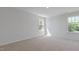 Spacious bedroom illuminated by natural light from two windows overlooking the backyard at 261 Hawksmoore Ln, Lillington, NC 27546