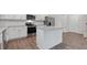 Bright kitchen features stainless steel appliances, white cabinets, an island and granite countertops at 261 Hawksmoore Ln, Lillington, NC 27546
