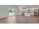 Bright open kitchen features white cabinets, stainless steel appliances, and wood-look floors at 261 Hawksmoore Ln, Lillington, NC 27546