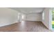 Spacious living room with wood-look floors and neutral walls, plenty of space to relax or entertain at 261 Hawksmoore Ln, Lillington, NC 27546
