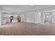 Expansive living space features white kitchen, wood-look floors, and neutral walls at 261 Hawksmoore Ln, Lillington, NC 27546