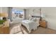 Relaxing bedroom with a queen bed, soft lighting, and a view of the neighborhood through a sunny window at 269 Hawksmoore Ln, Lillington, NC 27546