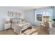 Stylish bedroom with a queen bed, cozy linens, and a large window overlooking the yard providing natural light at 269 Hawksmoore Ln, Lillington, NC 27546
