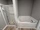 Bathroom featuring a glass enclosed shower and a tub at 271 Starry Sky Dr, Benson, NC 27504