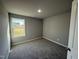 A cozy bedroom with plush carpeting and natural light from the window at 271 Starry Sky Dr, Benson, NC 27504