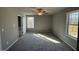 Bright bedroom featuring plush carpeting, a ceiling fan, and access to a balcony at 271 Starry Sky Dr, Benson, NC 27504