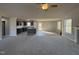 Open kitchen with stainless steel appliances, island, and sleek countertops, seamlessly blending into the living area at 271 Starry Sky Dr, Benson, NC 27504