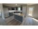 Modern kitchen with granite counters, stainless appliances, island, and access to outdoor deck, blending into the living area at 271 Starry Sky Dr, Benson, NC 27504