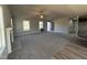 Open-concept living area with vaulted ceilings, carpeted floors, fireplace, and access to other rooms at 271 Starry Sky Dr, Benson, NC 27504