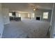 Spacious living room with fireplace, ceiling fan, and neutral color palette, seamlessly connecting to the kitchen at 271 Starry Sky Dr, Benson, NC 27504