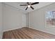 Bright bedroom features vinyl flooring, neutral paint and a ceiling fan at 2810 Hickory Hill Rd, Burlington, NC 27215