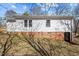Home's side showcasing brick foundation and access to the basement at 2810 Hickory Hill Rd, Burlington, NC 27215