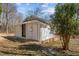 Home featuring a side entrance, surrounded by mature trees and greenery at 2810 Hickory Hill Rd, Burlington, NC 27215