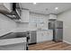 Kitchen features white cabinets, stainless steel appliances, stone countertops, and new vinyl floors at 2810 Hickory Hill Rd, Burlington, NC 27215