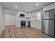 Modern kitchen featuring stainless steel appliances, white cabinets, subway tile backsplash, and vinyl flooring at 2810 Hickory Hill Rd, Burlington, NC 27215