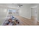 Bright living room with fresh paint, new flooring, ceiling fan, and abundant natural light from updated windows at 2810 Hickory Hill Rd, Burlington, NC 27215