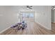 Living room showcasing new flooring, ceiling fan, and three large windows that provide plenty of natural light at 2810 Hickory Hill Rd, Burlington, NC 27215