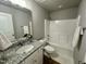 This bathroom features a granite vanity top, tub, shower, and great lighting at 349 Earnest Way # 21, Kenly, NC 27542