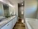 Bright bathroom features a double sink vanity, granite countertop, and separate tub and shower at 349 Earnest Way # 21, Kenly, NC 27542