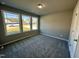 This bedroom features three windows offering ample natural light and neutral walls at 349 Earnest Way # 21, Kenly, NC 27542