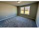 This bedroom features two windows offering ample natural light and neutral walls at 349 Earnest Way # 21, Kenly, NC 27542