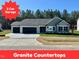 Charming single-story home featuring a three-car garage and well-manicured front yard at 349 Earnest Way # 21, Kenly, NC 27542