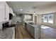 Modern kitchen with stainless steel appliances, a gray kitchen island, granite countertops, and ample cabinet space at 349 Earnest Way # 21, Kenly, NC 27542