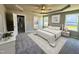 Inviting main bedroom with a tray ceiling, soft carpet, and access to an ensuite bathroom and walk-in closet at 349 Earnest Way # 21, Kenly, NC 27542
