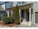 Inviting front porch with decorative columns, lush landscaping, and a cozy seating area at 3517 Eastern Branch Rd, Raleigh, NC 27610