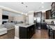 Spacious kitchen with a large island, stainless steel appliances, and dark wood cabinets at 3517 Eastern Branch Rd, Raleigh, NC 27610