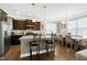 Modern kitchen with stainless steel appliances, dark wood cabinets, granite countertops, and an island with seating at 3517 Eastern Branch Rd, Raleigh, NC 27610