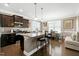 Bright kitchen featuring a granite island with bar stools, stainless appliances, and an adjacent dining area at 3517 Eastern Branch Rd, Raleigh, NC 27610
