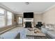 Cozy living room with a fireplace, large TV, comfortable seating, and elegant decor at 3517 Eastern Branch Rd, Raleigh, NC 27610