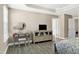 A vanity with a round mirror and TV make this main bedroom a calm and relaxing space at 3517 Eastern Branch Rd, Raleigh, NC 27610