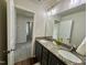 Bathroom with double sinks and vanity with granite countertop and modern lighting at 377 Earnest Way, Kenly, NC 27542