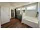 Bright bathroom featuring a soaking tub and dark cabinets with granite counters at 377 Earnest Way, Kenly, NC 27542