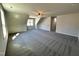 Expansive carpeted bonus room with a ceiling fan and a view of the outdoors at 377 Earnest Way, Kenly, NC 27542