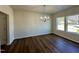 Dining room with gorgeous hardwood floors, large windows, and a modern chandelier at 377 Earnest Way, Kenly, NC 27542