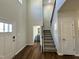 Bright foyer with hardwood floors, staircase, and view of a half bathroom at 377 Earnest Way, Kenly, NC 27542