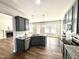 Kitchen boasts stainless steel appliances, granite countertops, hardwood floors, and dark cabinets at 377 Earnest Way, Kenly, NC 27542