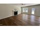 Living room with hardwood floors, a fireplace, a ceiling fan, and access to the backyard at 377 Earnest Way, Kenly, NC 27542
