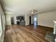 Open-concept living area with hardwood floors, fireplace, and backyard view at 377 Earnest Way, Kenly, NC 27542