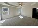 This spacious main bedroom features large windows, a tray ceiling, and a ceiling fan at 377 Earnest Way, Kenly, NC 27542