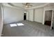 Carpeted main bedroom with tray ceiling and fan, large windows, and an ensuite bathroom at 377 Earnest Way, Kenly, NC 27542