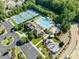Community aerial showcasing tennis courts, large pool with slide, playground, clubhouse, parking and landscaping at 3804 Prince Noah, Wake Forest, NC 27587