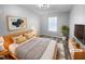 Bright bedroom featuring a wood frame bed, stylish decor and a leafy plant in a modern setting at 3804 Prince Noah, Wake Forest, NC 27587